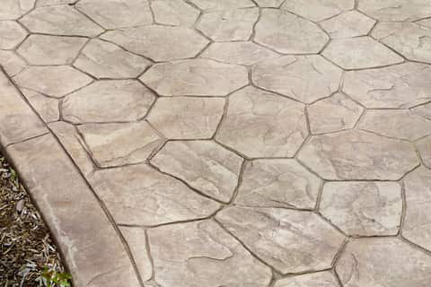 Custom stamped concrete walkway stone pattern with boarder. Colored concrete tan in color. 